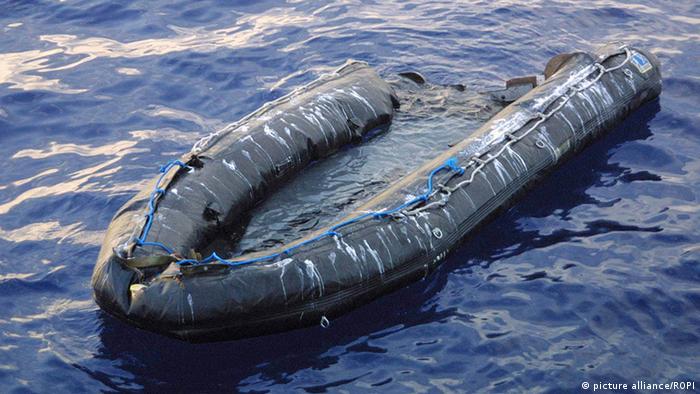 An inflatable dinghy floats in the water