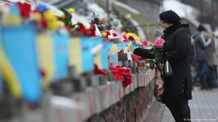 Woman lays flowers