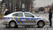 A police officer patrols near a restaurant where a gunman opened fire in Uhersky Brod, East of the Czech Republic, on Tuesday, Feb. 2015. The gunman was arrested. There may be injured and dead people, police spokesman Pavel Benedikt Stransky says. (CTK Photo/Dalibor Gluck)