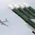 A plane flies in the sky above a Buk missile system