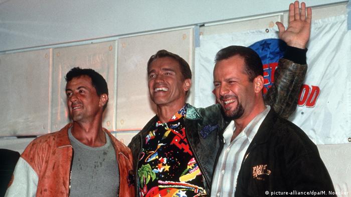 Stallone & Schwarzenegger & Willis smiling 