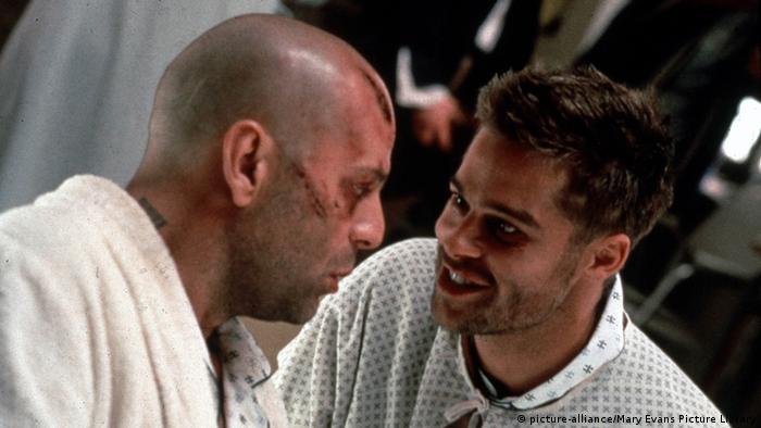 Film still 12 monkeys, Bruce Willis & Brad Pitt, two men look at each other