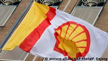 FILE - In this Monday, April 7, 2014 file photo, a flag bearing the company logo of Royal Dutch Shell, an Anglo-Dutch oil and gas company, flies outside the head office in The Hague, Netherlands. Royal Dutch Shell said Wednesday, April 8, 2015, it has agreed to buy gas producer BG Group for 47 billion pounds (69.7 billion U.S. dollars) in a cash and stock takeover. (AP Photo/Peter Dejong, File)