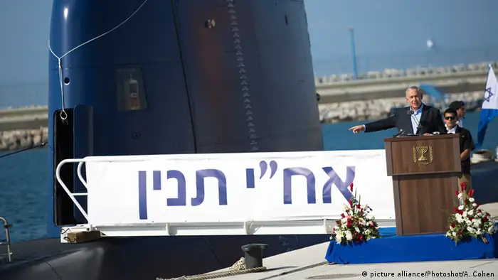 Israeli Prime Minister Benjamin Netanyahu gives a speech next to a Dolphin AIP class submarine at a naval base in Haifa