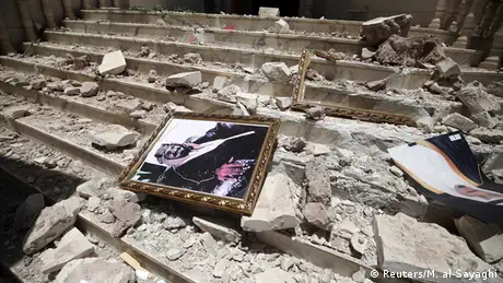 Picture of Saudi Arabia's King Salman bin Abdulaziz lies amid debris in Yemen
