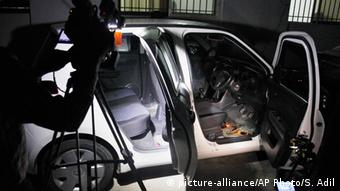 A Pakistani cameraman films the damaged car of a prominent women's rights activist Sabeen Mehmud following an attack on Mehmud in Karachi, Pakistan Friday, April 24, 2015 (AP Photo/Shakil Adil)