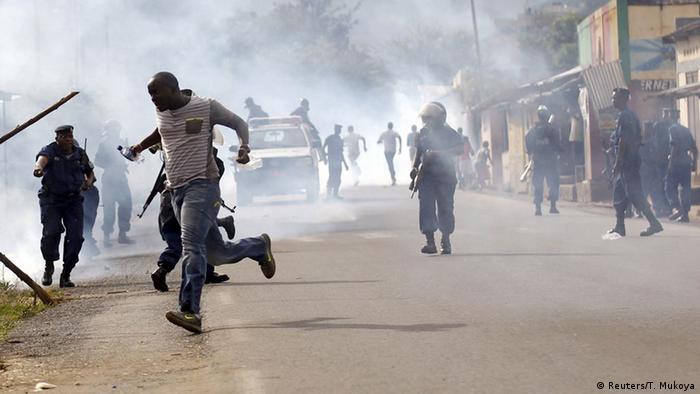 Protesters run away from police amid a cloud of smoke (Reuters/T. Mukoya)