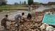 Residents collect bricks after their house collapsed following heavy rain and winds in Peshawar, Pakistan in April, 2015 Residents collect bricks after their house collapsed following heavy rain and winds in Peshawar, Pakistan in April, 2015