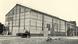 A large building covered in panes of glass, resembling a greenhouse, black and white A large building covered in panes of glass, resembling a greenhouse, black and white