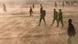 Photo: People walking through sand wind Photo: People walking through sand wind