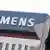 A red traffic light is seen in front of the Siemens headquarters in Munich.