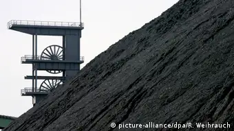Гора каменного угля и шахтный эксплуатационный копёр