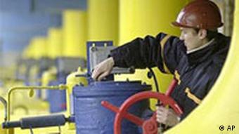 A Ukrainian worker operates valves in a gas storage and transit point