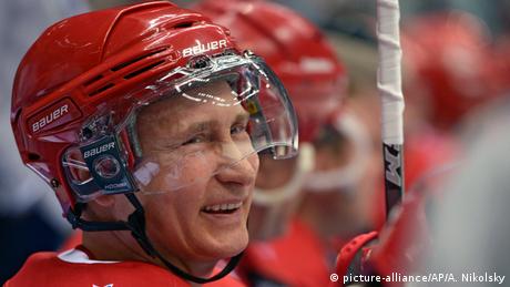 Russian President Vladimir Putin smiles during an exhibition hockey game
