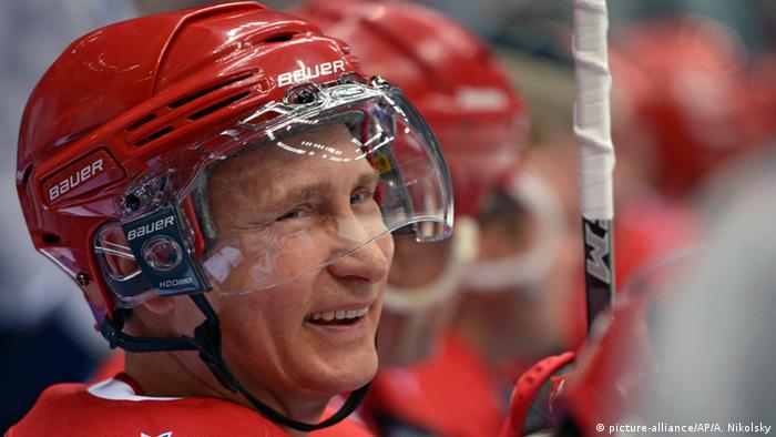 Russian President Vladimir Putin smiles during an exhibition hockey game