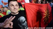 18.05.2015+++ epa04755855 A supporter of the ruling VMRO DPMNE party dressed in a T-shirt depicting the face of Russian President Vladimir Putin, shows the sign for United Macedonia during a rally in support for the government, in Skopje, The Former Yugoslav Republic of Macedonia on 18 May 2015. After the big opposition meeting a day earlier in Skopje when opposition members asked for resignation of the government, the ruling VMRO DPMNE party organized a counter-protest to support the government and Prime Minister Nikola Gruevski. Tens of thousands people attended the rally. EPA/GEORGI LICOVSKI