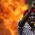 A protester gestures in front of a burning barricade during a protest against Burundi President Pierre Nkurunziza and his bid for a third term in Bujumbura, Burundi, May 21, 2015 (Photo: REUTERS/Goran Tomasevic)