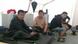 Three men sit in the tent that has become their home in Linz Three men sit in the tent that has become their home in Linz