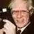 Andy Warhol holding a camera
