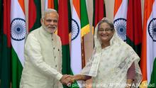 6.6.2015 Indian Prime Minister Narendra Modi, left, and Bangladesh¿s Prime Minister Sheikh Hasina shake hands in Dhaka, Bangladesh, Saturday, June 6, 2015. India and Bangladesh on Saturday finalized a much-delayed land swap agreement to settle a long-running border dispute. The deal, initially reached in 1974 but only recently ratified by India's Parliament, calls for the transfer of 111 border enclaves to Bangladesh in exchange for 51 that will become part of India. (AP Photo/A.M. Ahad)