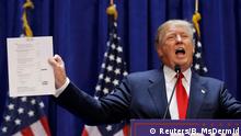 June 16, 2015 U.S. Republican presidential candidate, real estate mogul and TV personality Donald Trump holds up his financial statement showing his net worth as he formally announces his campaign for the 2016 Republican presidential nomination during an event at Trump Tower in New York June 16, 2015. REUTERS/Brendan McDermid