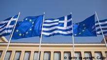 ATHENS, GREECE - JANUARY 23: The national flag of Greece and the flag of the European Union fly above a government building ahead of the general election on Sunday on January 23, 2015 in Athens, Greece. According to the latest opinion polls, the left-wing Syriza party are poised to defeat Prime Minister Antonis Samaras' conservative New Democracy party in the election, which will take place on Sunday. European leaders fear that Greece could abandon the Euro, write off some of its national debt and put an end to the country's austerity by renegotiating the terms of its bailout if the radical Syriza party comes to power. Greece's potential withdrawal from the eurozone has become known as the 'Grexit'. (Photo by Matt Cardy/Getty Images)