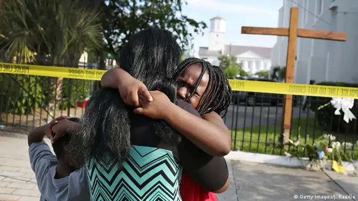 A woman comforts her daughter as they stand in front of the Emanuel African Methodist Episcopal Church following a mass shooting in Charleston, South Carolina (Getty Images/J. Raedle)