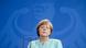 Bundeskanzlerin Angela Merkel mit geschlossenen Augen vor einer Wand mit dem Bundesadler Bundeskanzlerin Angela Merkel mit geschlossenen Augen vor einer Wand mit dem Bundesadler