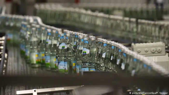 Mineralwasserflaschen auf einem Produktionsband in einer Abfüllanlage. 