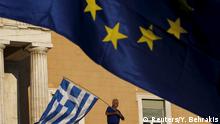 22.06.2015 ***** A protester waves a Greek flag at the entrance of the parliament building during a rally calling on the government to clinch a deal with its international creditors and secure Greece's future in the Eurozone, in Athens, Greece, in this June 22, 2015 file photo. To match Special Report EUROZONE-GREECE/NEGOTIATIONS REUTERS/Yannis Behrakis/Files