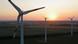 In this aerial view electricity-producing wind turbines spin at a wind farm In this aerial view electricity-producing wind turbines spin at a wind farm
