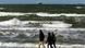 People walking on Baltic Sea beach People walking on Baltic Sea beach