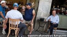 People sit in a cafe in Athens, Greece, 24 June 2015. Photo: Socrates Baltagiannis/dpa