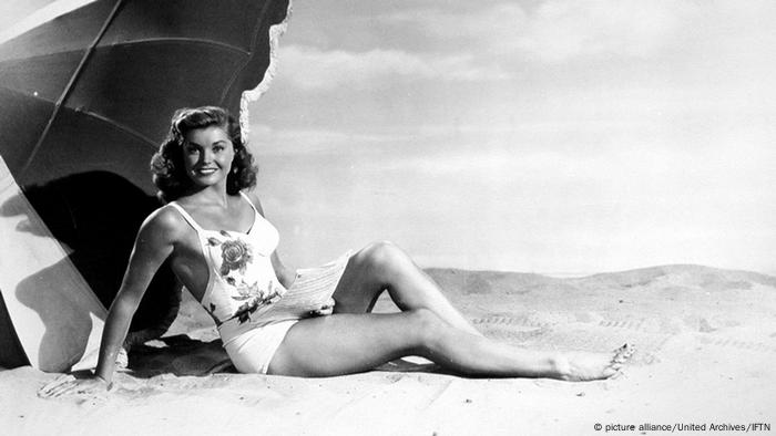  Esther Williams posing in a suit on sand