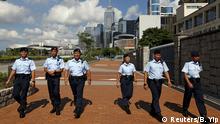 Policemen patrol outside the People's Liberation Army camp adjacent to Legislative Council and government headquarters in Hong Kong, China June 17, 2015. Hong Kong lawmakers began a debate on Wednesday on a Beijing-backed electoral reform proposal that will define the city's democratic future and could trigger fresh protests in the Chinese-controlled city. The former British colony has reinforced security after mass protests crippled parts of the Asian financial hub late last year, presenting China's ruling Communist Party with one of its biggest political challenges in decades. REUTERS/Bobby Yip