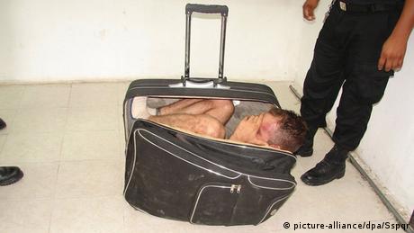 man wedged in suitcase