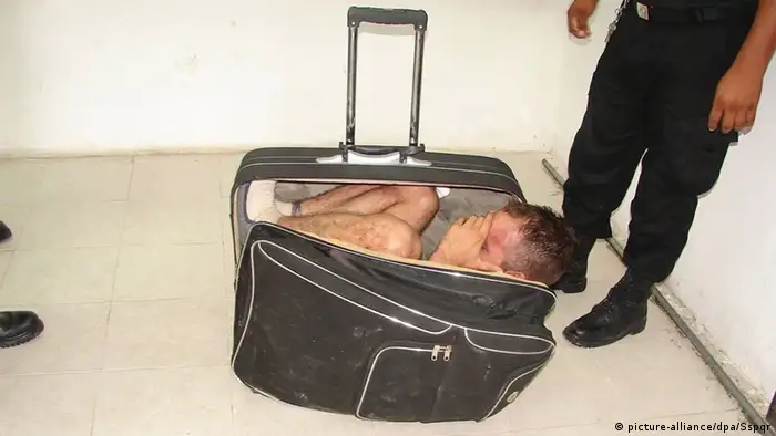 man wedged in suitcase