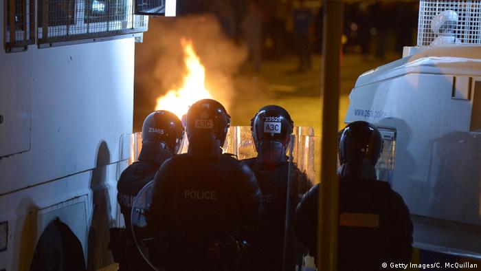 Police dressed in riot gear attempt to contain disturbances along the controversial Ardoyne flashpoint area on July 13, 2015 in Belfast.