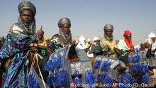 Muslim horsemen dressed in ceremonial robes as they prepare to parade for the Durbar festival in Kano, Nigeria, Friday, Nov. 12, 2004. Muslim faithful celebrate the Durber at the culmination of Ramadan fasting. (AP Photo/George Osodi)