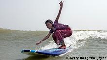 COX'S BAZAR, BANGLADESH - APRIL 14: 12 year old Rifa, who has been working for 4 years, surfs April 14, 2014 in Cox's Bazar, Bangladesh. A group of 10-12 year old female beach vendors, most of whom have dropped out of school to help support their families, have been learning to surf for the past three months in preparation for the annual Cox's Bazar surf competition. 24 year old surfer, lifeguard and beach worker Rashed Alam, has been teaching and mentoring the girls for 3 months. Like the girls, Alam dropped out of school and started working on the beach to help support his family at a young age. He started surfing when he was 16. He says that his way of giving back is by ensuring that girls get a good future through surfing. (Photo by Allison Joyce/Getty Images)