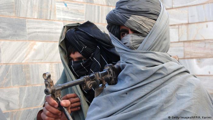 Surrendering Taliban militants stand with their weapons as they are presented to the media in Herat on December 5, 2010 (Photo: Aref Karimi/AFP/Getty Images)