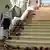 Наталья Потанина спускается по лестнице своего дворца