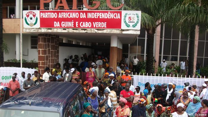 Crowds converge outside PAIGC party offices in Guinea-Bissau.