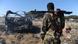 A soldier looks at the burnt out wreckage of a car, following an al-Shabab suicide bombing A soldier looks at the burnt out wreckage of a car, following an al-Shabab suicide bombing