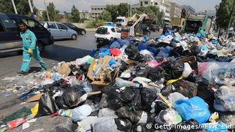Garbage collectors remove waste from a street in Beirut's eastern suburb of Dora to a temporary location outside of the Lebanese capital on August 31, 2015.