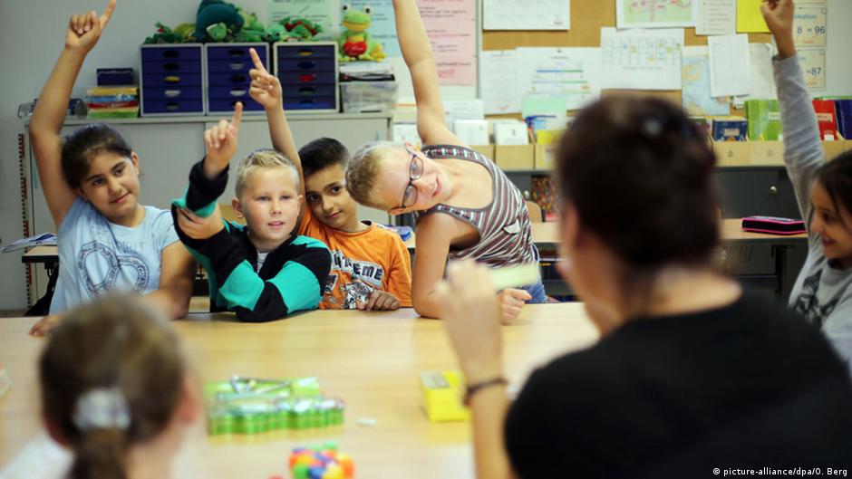 School children raise their hands
