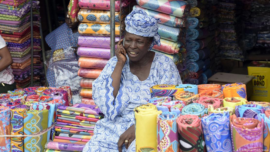 A shop owner makes a call at Oshodi market in Lagos
