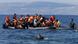 Migrants cling to a boat off the Greek coast Migrants cling to a boat off the Greek coast