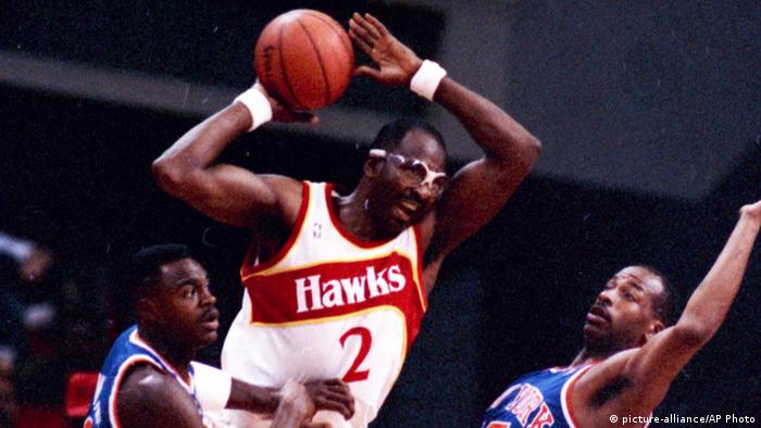Moses Malone in the Atlanta Hawks jersey catches a rebound