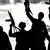 A silhouette of several militant with rifles